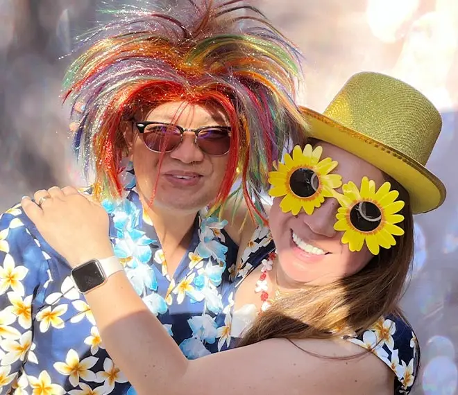 Happy couple posing with silly props at Glamoor Photo Booth rental in Los Angeles