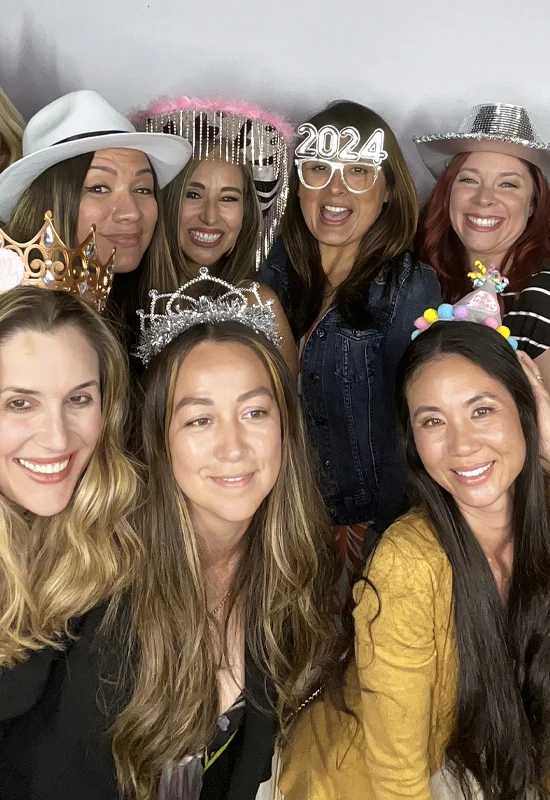 women having fun using photo booth at birthday party in Los Angeles
