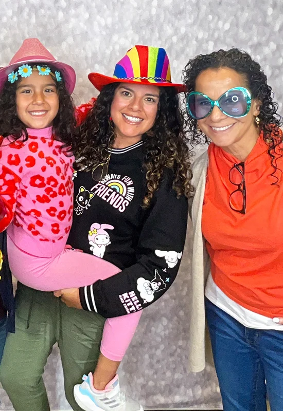 family group smiling using photo booth props including oversized glasses and costume glove in Hawthorne California