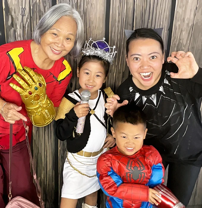 family posing in photo booth at school event in Gardena California with fun props and costumes