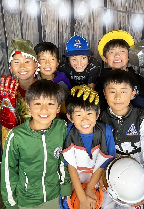 group of kids using photo booth with hats and superhero gloves at school event in Long Beach California