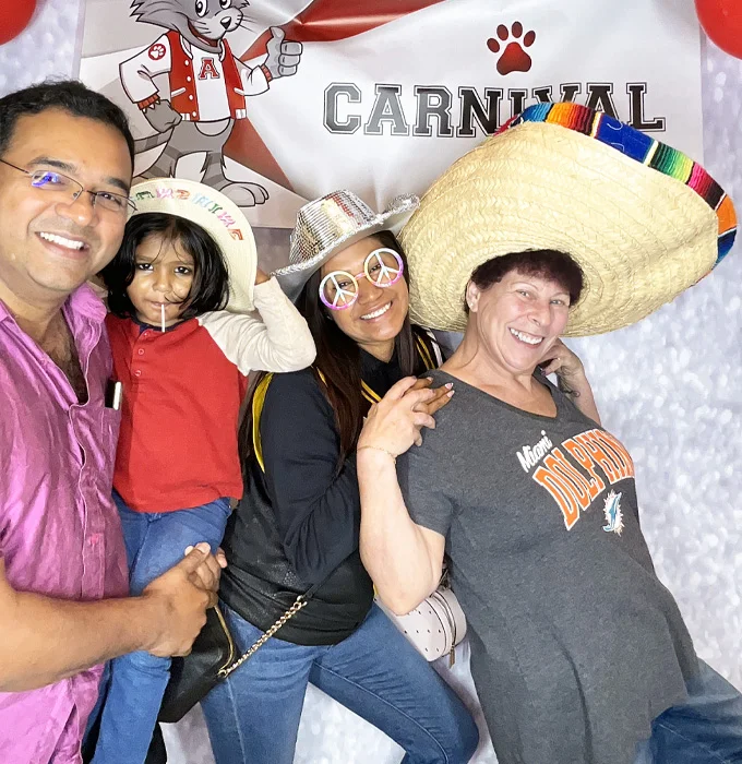 parents using photo booth with oversized hat at school event in Torrance California