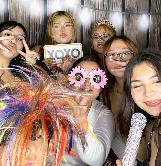 group of teen girls using photo booth at sweet 16 party in Southern California
