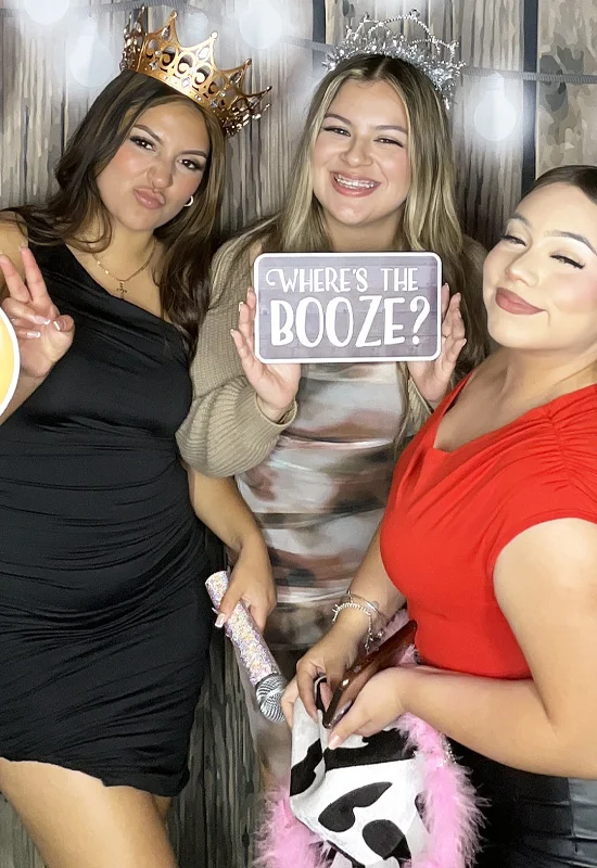 women using photo booth holding funny prop sign at wedding in Torrance California