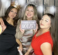 Three women posing with props at a wedding photo booth in Gardena, CA